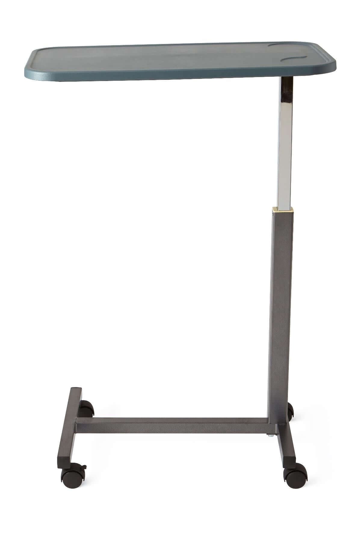 Composite-top overbed table with gray rectangular surface, height-adjustable chrome post, gray steel base, and four rolling