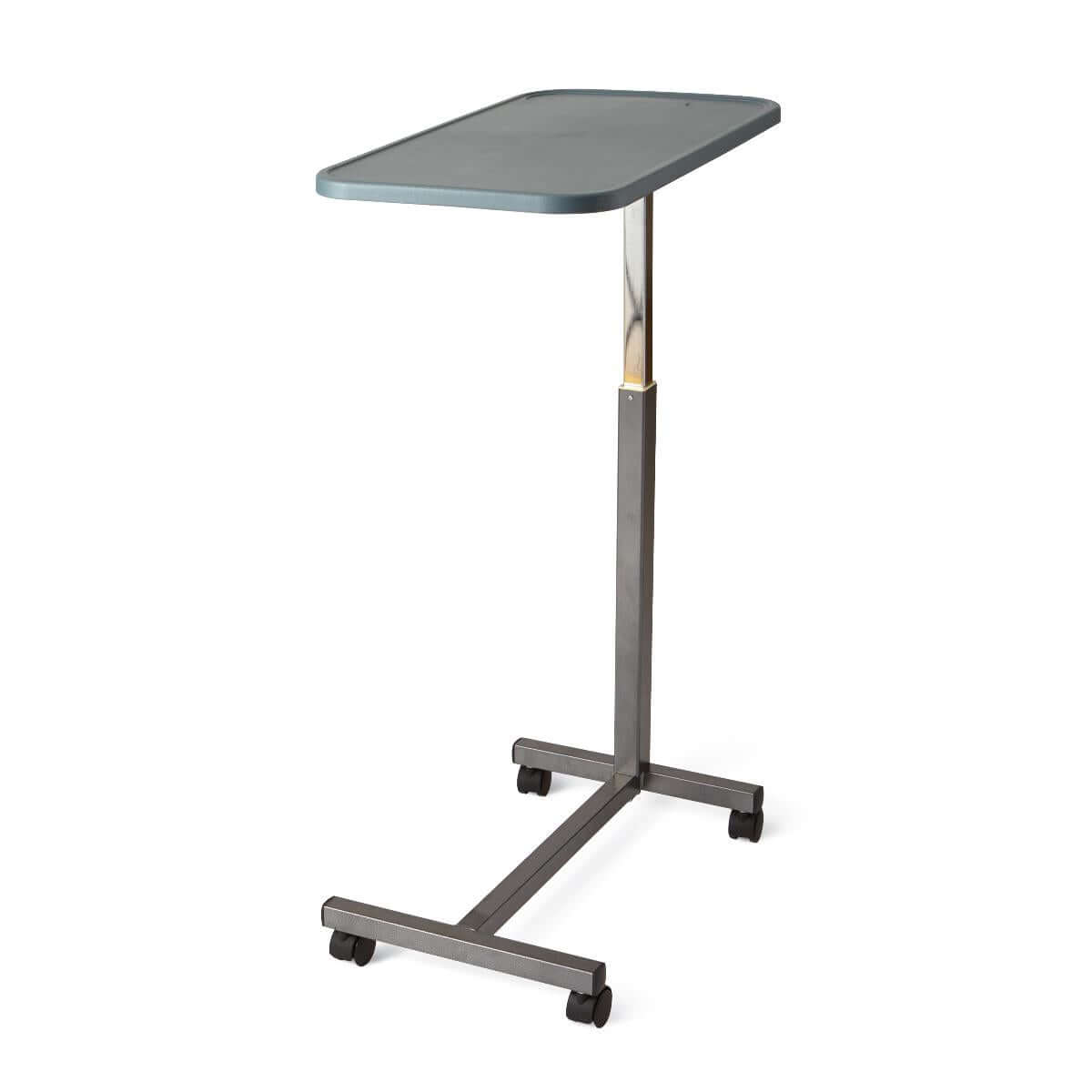 Composite-top overbed table with gray rectangular surface, height-adjustable chrome post, and four-caster rolling base
