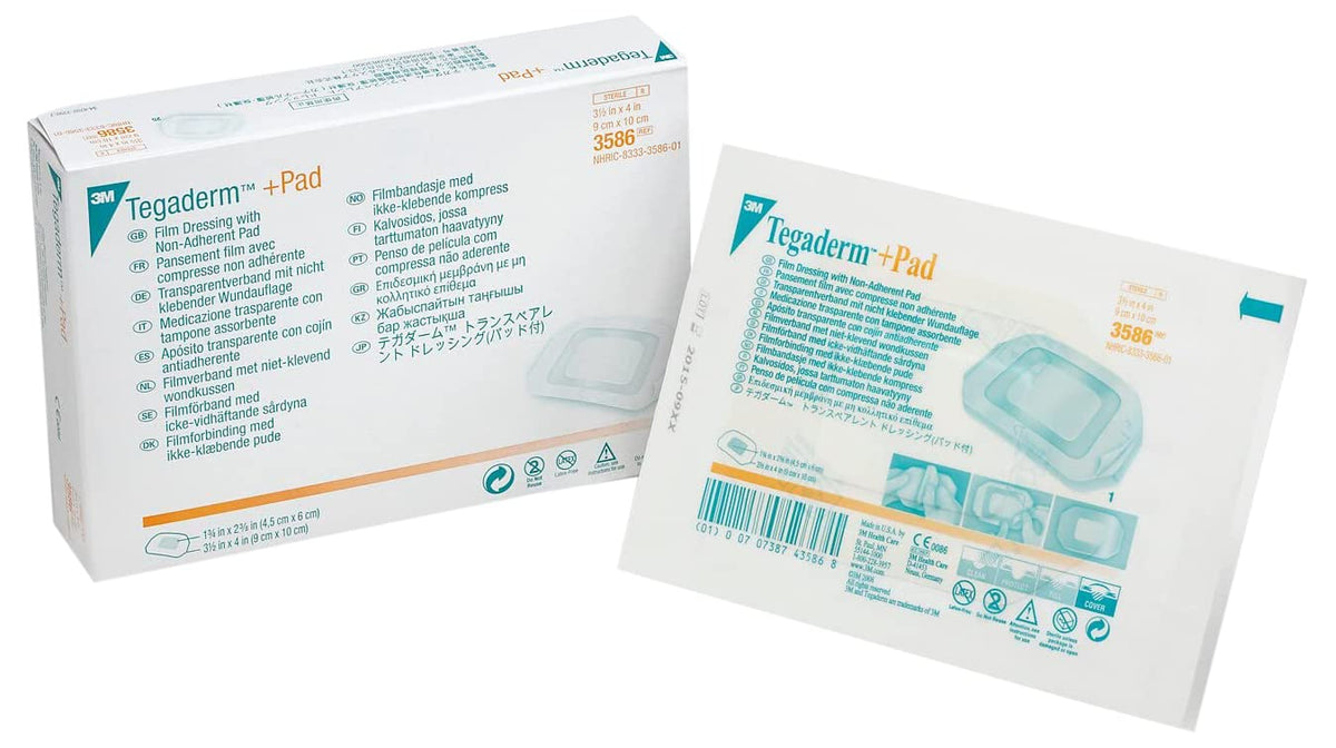 Tegaderm +Pad film dressing box beside a single sterile film dressing packet with non-adherent pad, teal border packaging