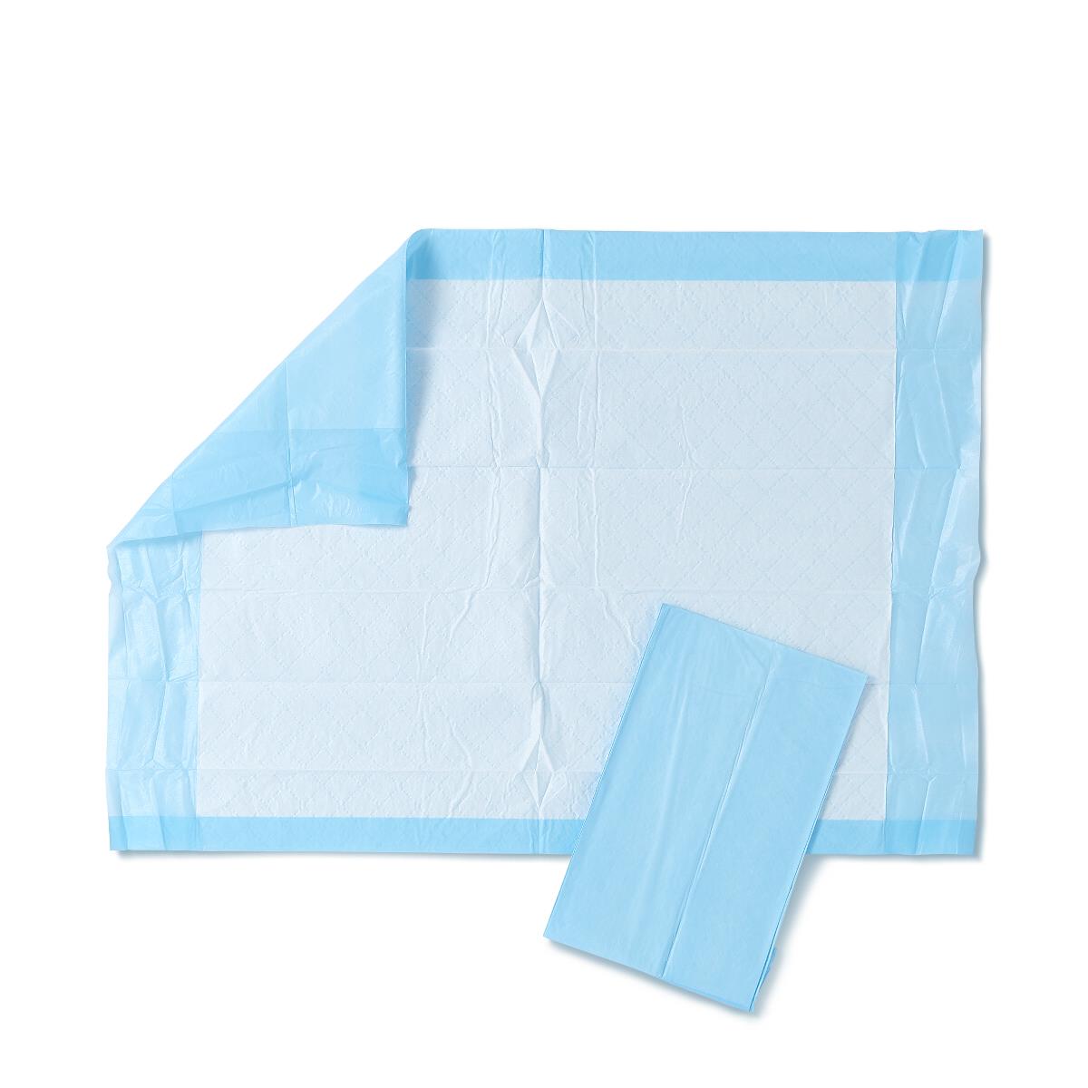 Disposable underpad unfolded showing white quilted top and light blue waterproof backing, with one folded pad alongside