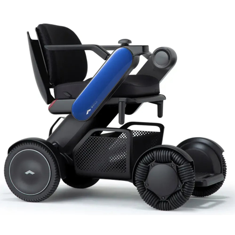 Power wheelchair with sleek black frame, blue armrest accent, joystick control, mesh storage basket, and wide ribbed front