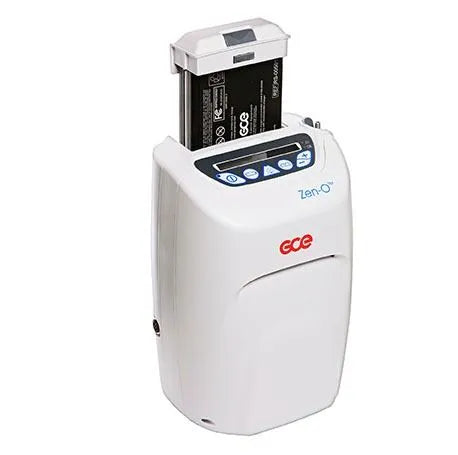 Portable oxygen concentrator with removable battery pack inserted on top, white housing with blue control buttons and GCE