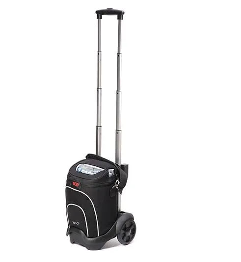 Portable oxygen concentrator in black carrying bag on wheeled trolley cart with extended telescoping handle