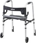 Rollator walker with padded seat, push-down brakes, and front wheels in silver and black
