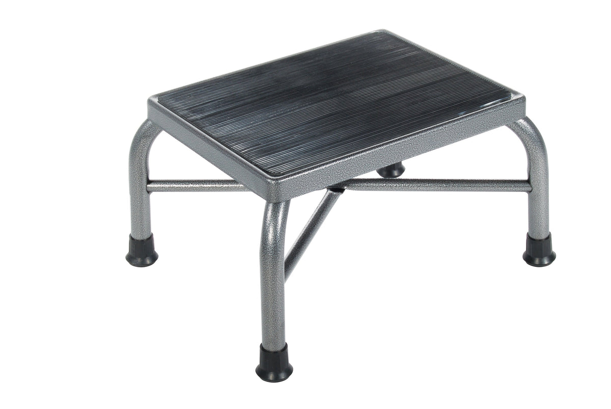 Step stool with silver steel tubular frame, black ribbed non-skid rubber platform, and rubber non-slip leg tips
