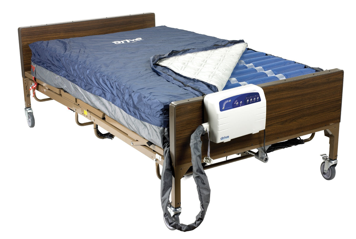 Alternating pressure low air loss mattress system with pump unit on hospital bed with wood grain rails and casters