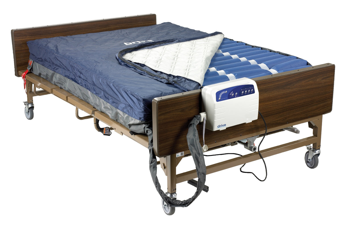 Alternating pressure low air loss mattress system with pump unit on a full-length hospital bed frame, cover partially folded