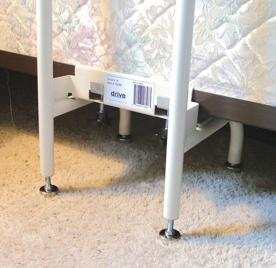 Bed assist rail base bracket with adjustable legs secured under a mattress and bed frame on carpet