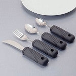 Adaptive silverware set with four black sure-grip handles including knife, fork, and two spoons on white surface
