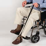 Leg lift strap in use by wheelchair user to assist lifting leg, shown in use position