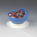 Scooper plate with curved inner wall and suction cup base, filled with mixed berries, in blue