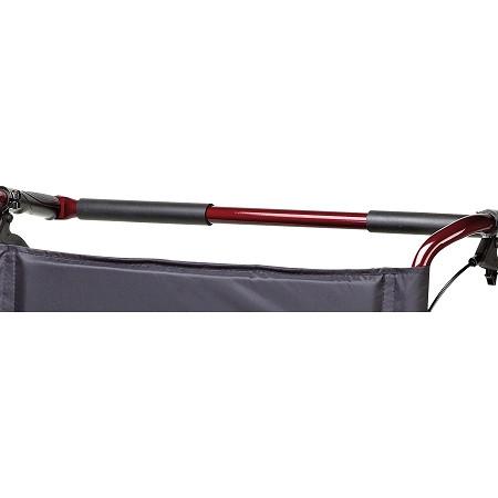Transport chair crossbar and storage pouch detail showing red metal frame tubes with gray fabric underseat bag