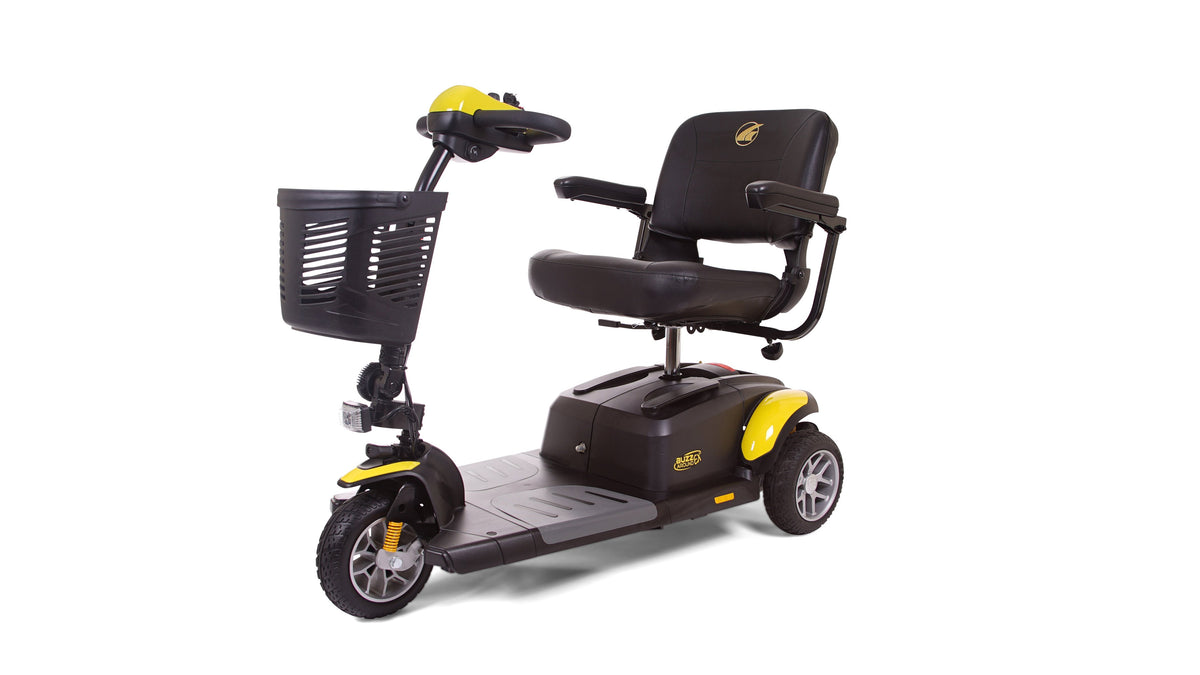 3-wheel mobility scooter in black and yellow with padded seat, armrests, tiller controls, and front basket on white