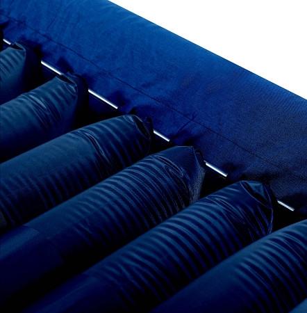 Alternating pressure mattress close-up showing navy blue air tube cells with fabric cover and metal connectors