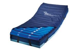 Alternating pressure mattress overlay with blue air cells and navy border on a foam base