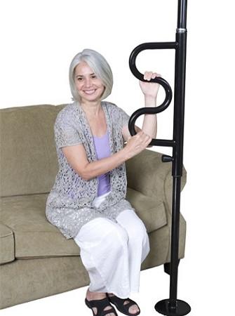 Floor-to-ceiling security pole with curved grab bar, shown with woman using it to assist rising from a sofa