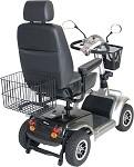 Wire rear basket mounted on a four-wheel power mobility scooter with high-back seat