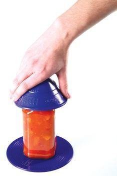 Dycem non-slip jar opener aid with blue pad and cap grip, hand demonstrating use on orange jar