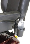 Power mobility drink holder attached to a power wheelchair armrest holding a clear water bottle