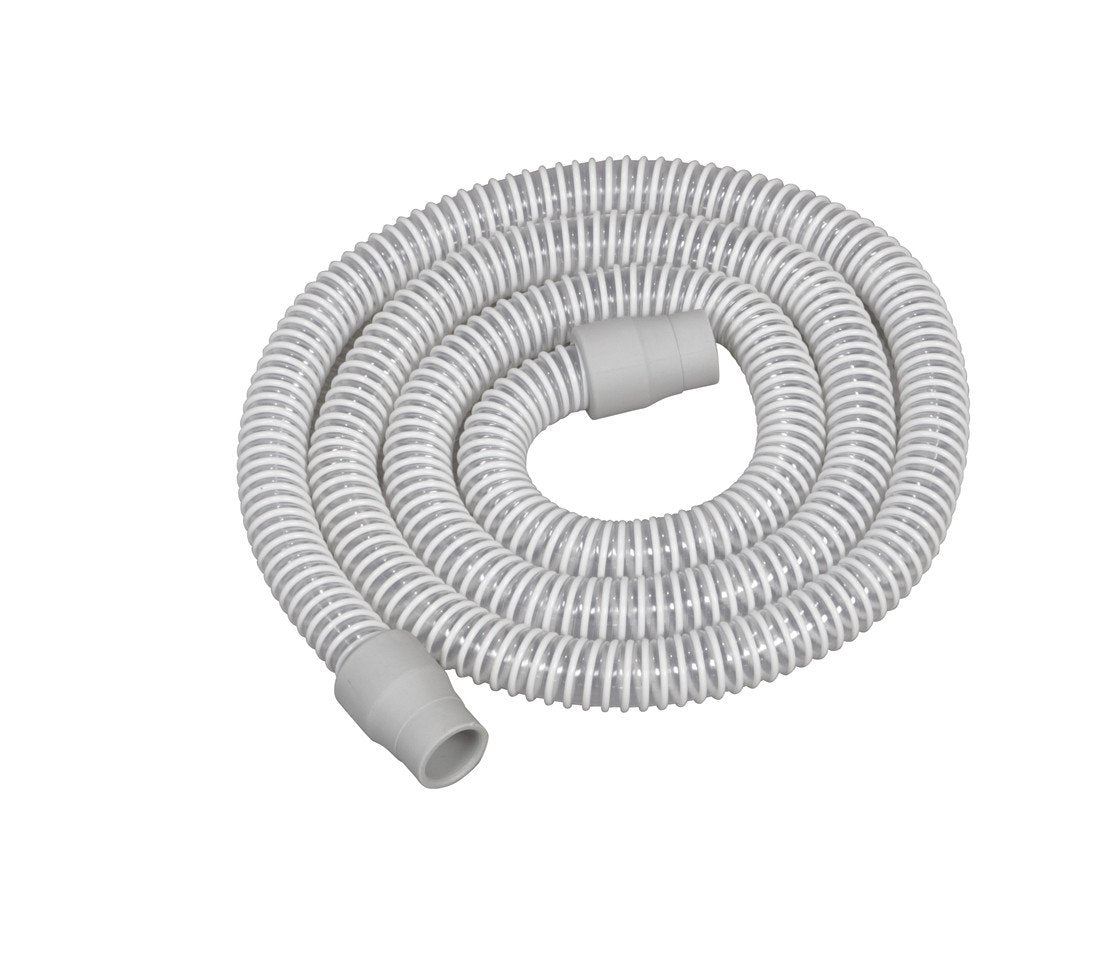CPAP tubing coiled on white background, gray ribbed flexible hose with connector cuffs on each end