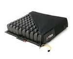 Wheelchair cushion with black segmented air cells and inflation valve on a flat base