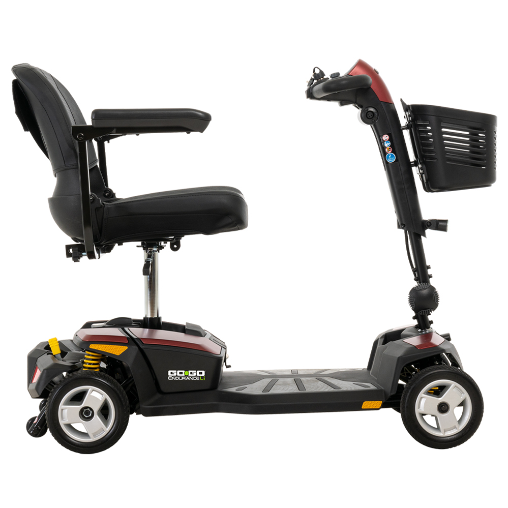4-wheel mobility scooter in red and black with padded seat, armrests, tiller controls, front basket, and yellow suspension