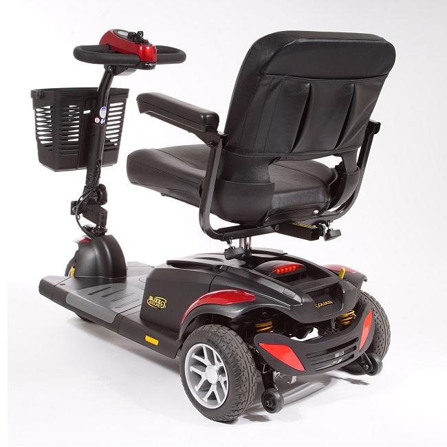 3-wheel power mobility scooter in black and red with padded captain's seat, tiller controls, and front basket