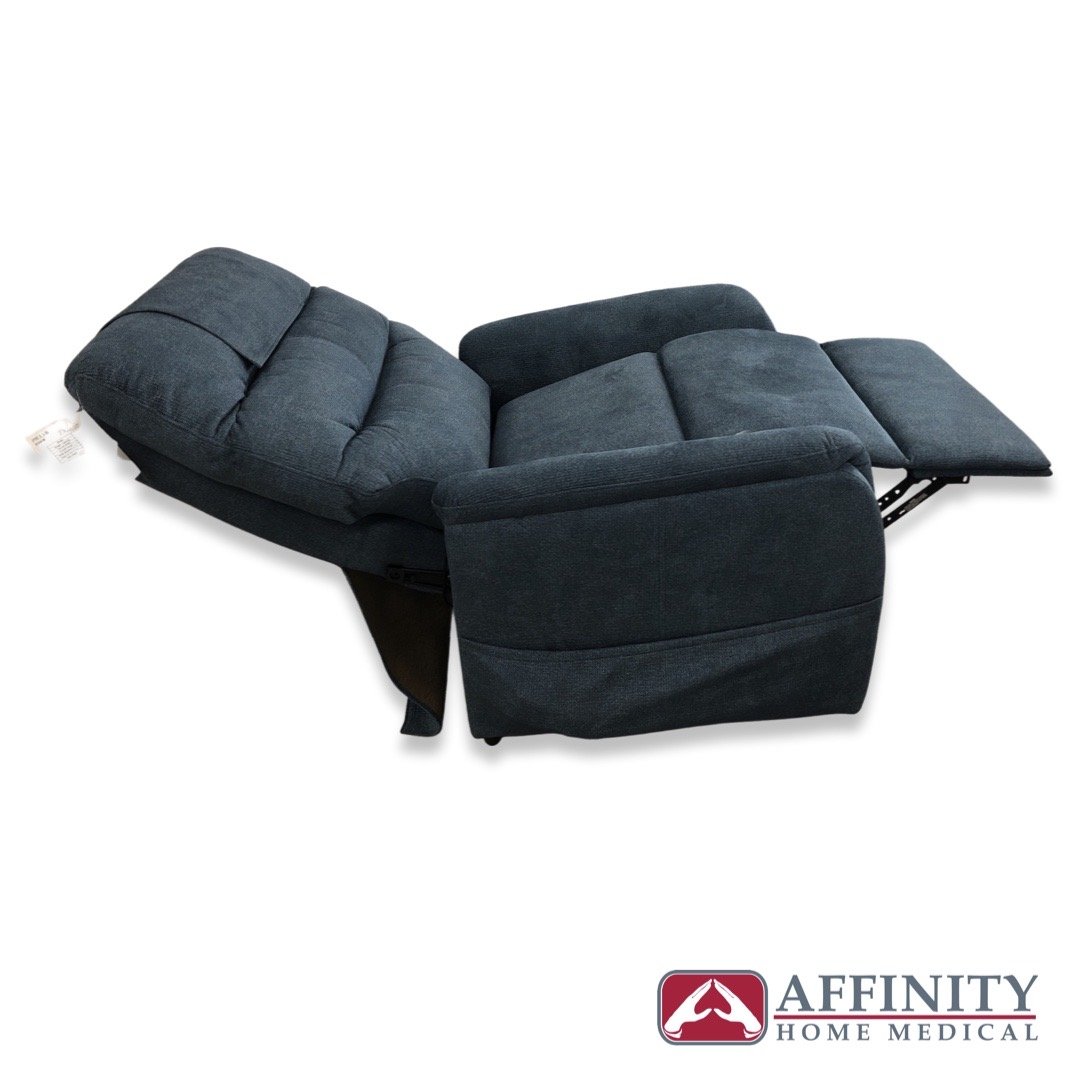Power lift recliner chair in dark blue fabric shown fully reclined with footrest extended, viewed from the side