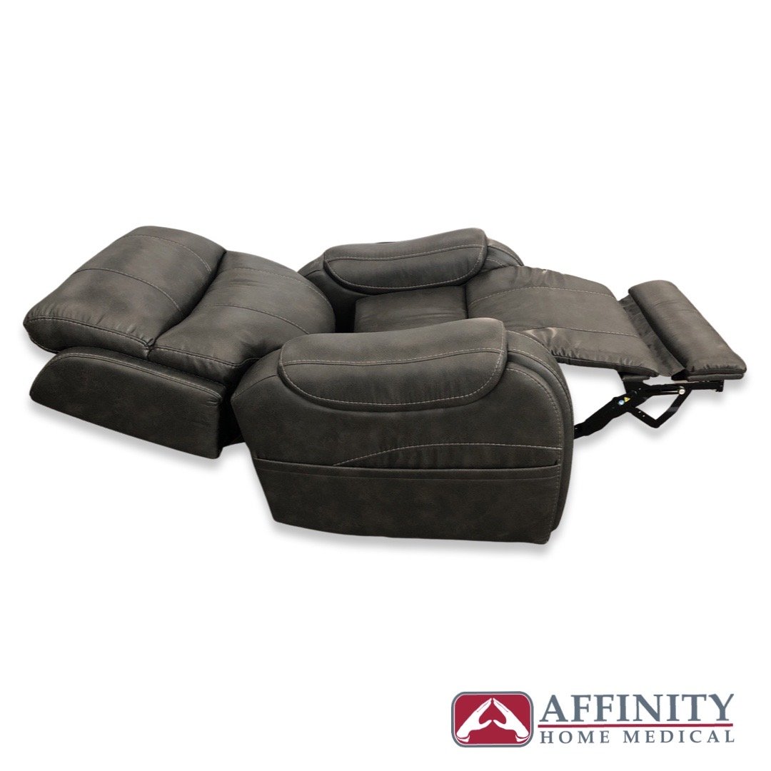 Power lift recliner chair in steel gray suede fabric, shown fully reclined with footrest extended and headrest raised
