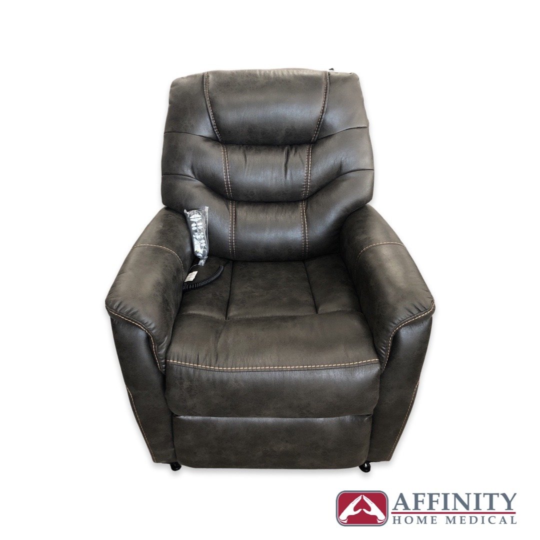Power lift chair in dark gray faux leather upholstery with tufted cushioning and side remote control, shown from the front