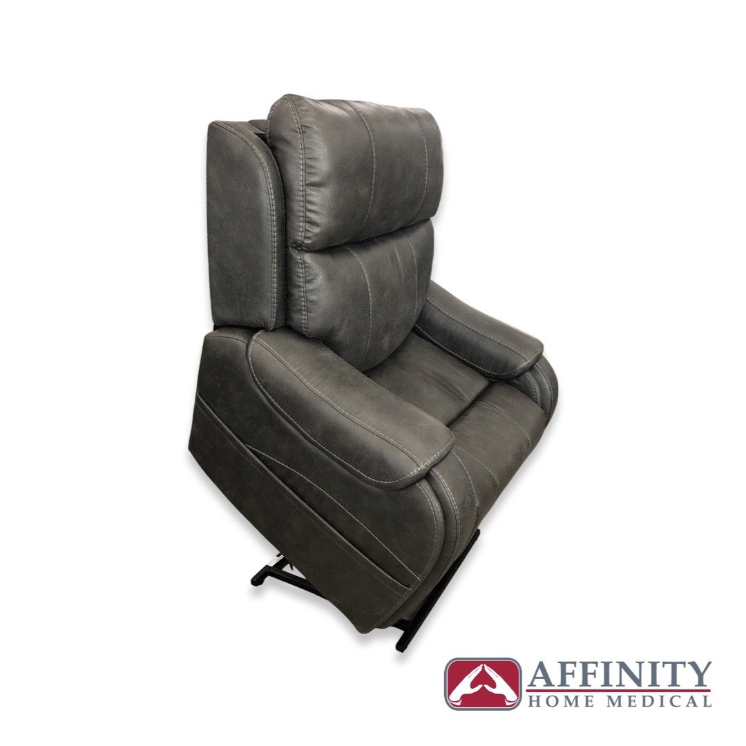 Power lift recliner chair in steel gray suede fabric, shown from a side angle in the upright seated position