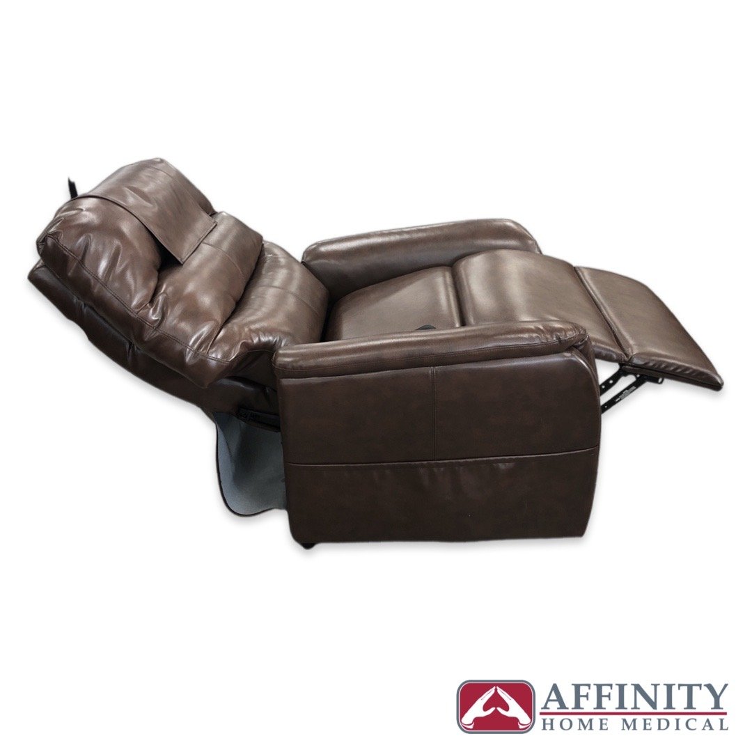 Power lift recliner chair in brown vinyl shown fully reclined with footrest extended, side angle view on white background