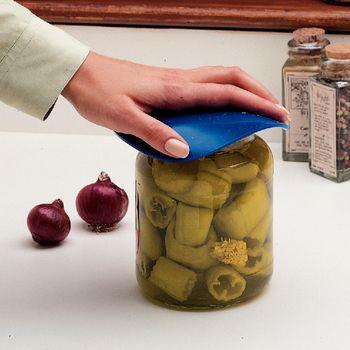 Dycem non-slip jar opener pad in blue being used to open a glass jar of peppers on a kitchen counter