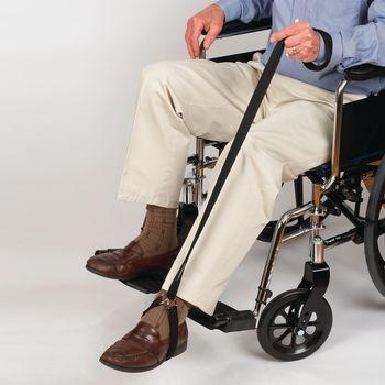 Leg lift strap in use by seated wheelchair user lifting one leg with both hands gripping the long handle