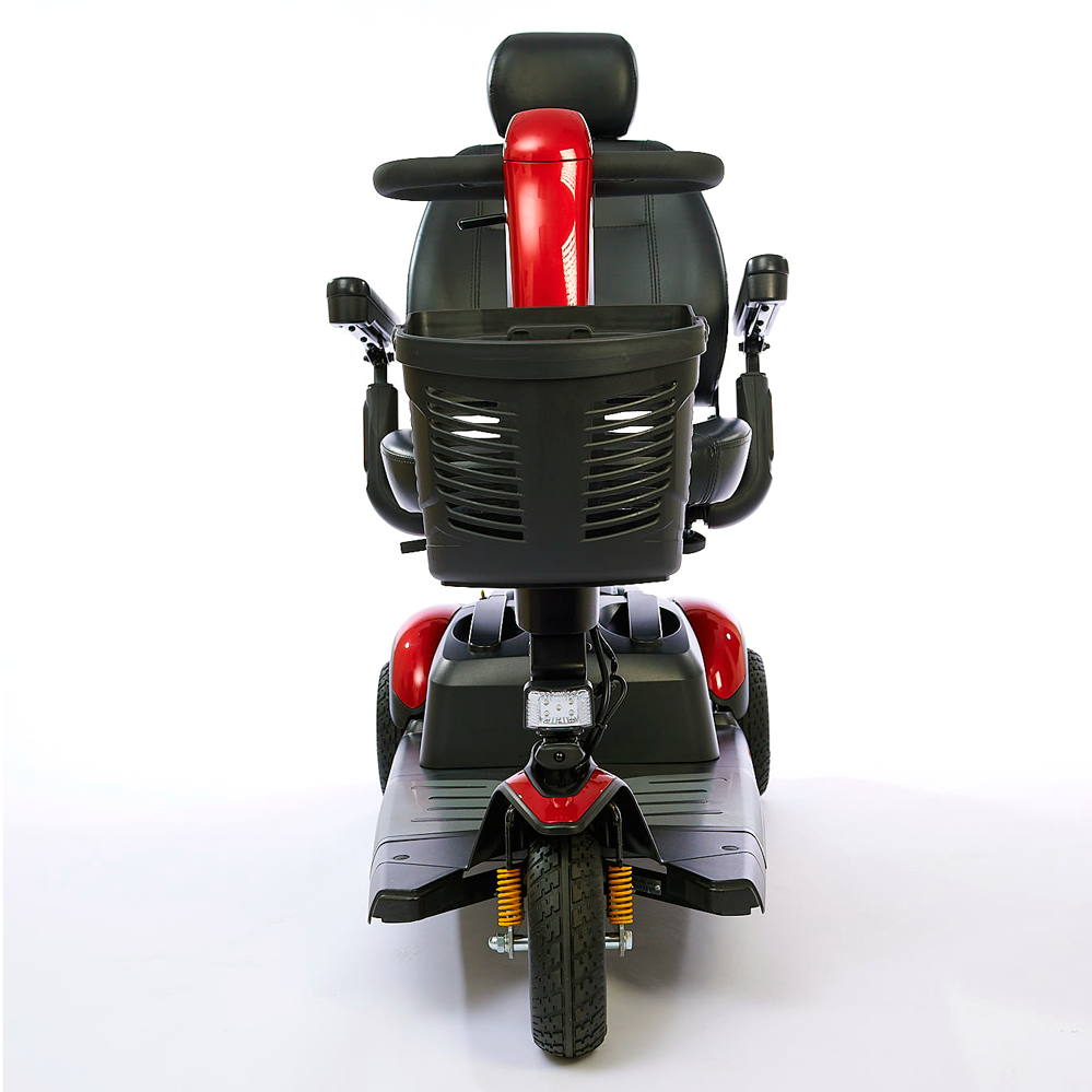 3-wheel power mobility scooter in red and black, front view, with front basket, headlight, suspension, and captain's seat