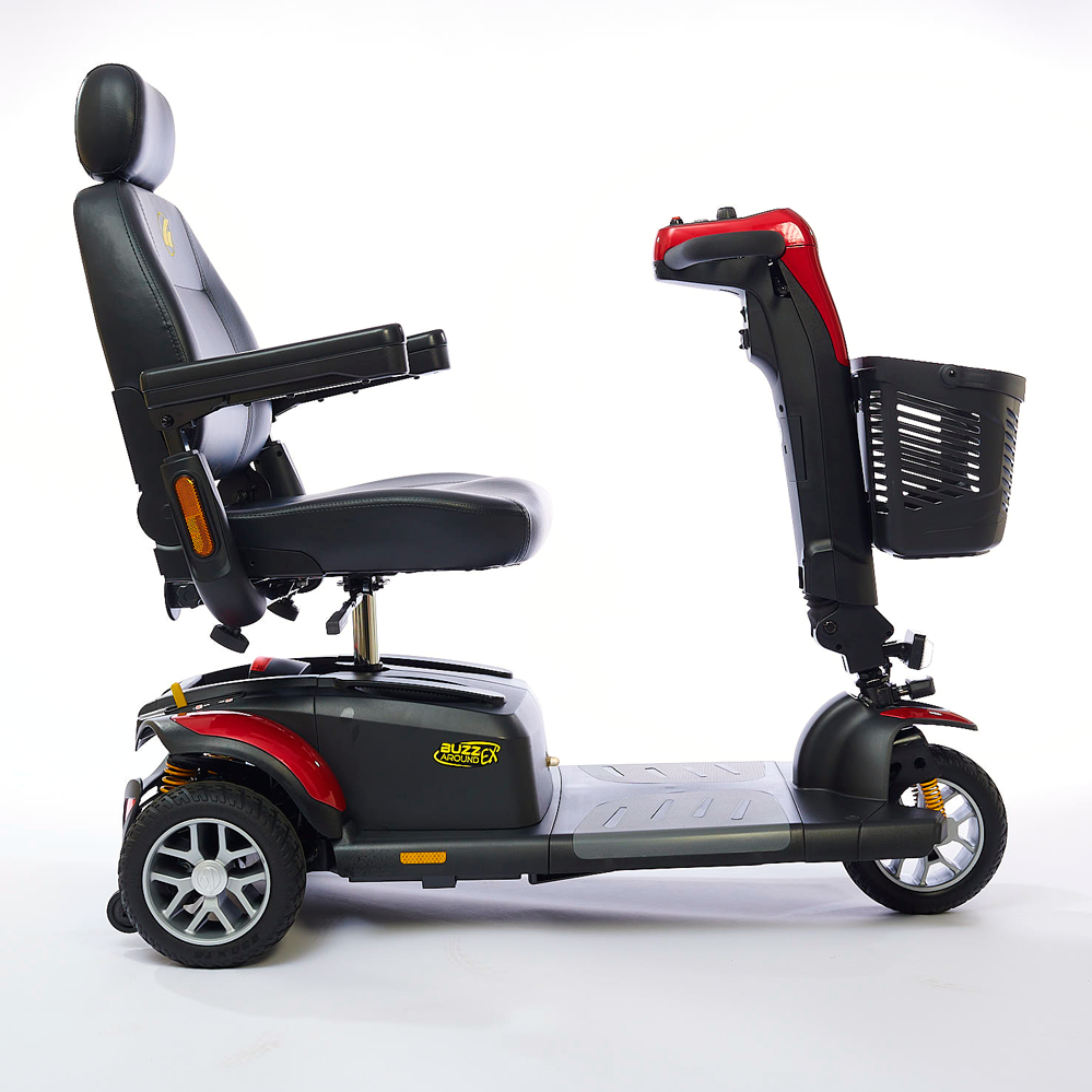 Power mobility scooter in red and black with high-back captain's seat, front basket, and three wheels, shown from the side