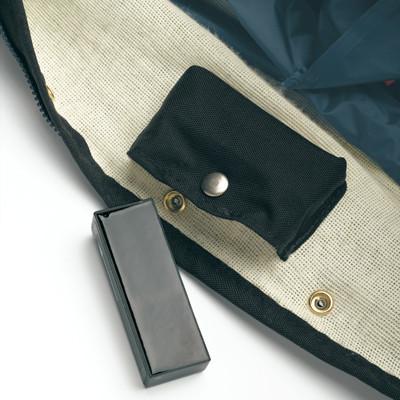 Alternating pressure mattress interior showing pump pouch with snap closure and small control unit on cream mesh surface