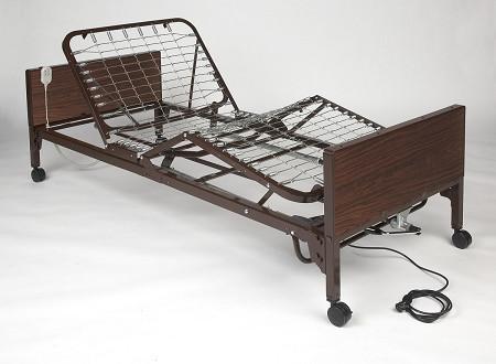 Semi-electric hospital bed with dark wood-grain finish, raised head section, spring frame, side rails, and wired hand