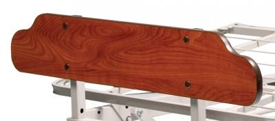 Hospital bed headboard with wood-grain finish attached to white metal bed frame
