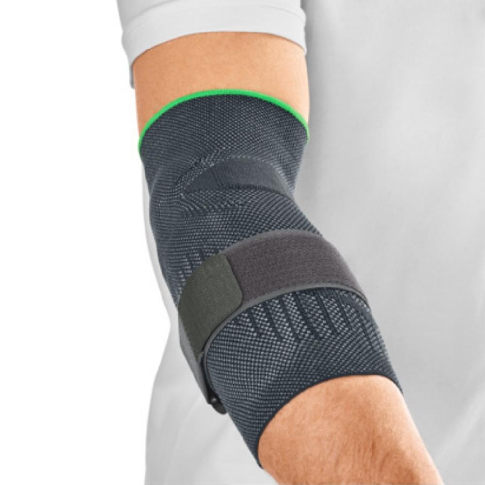 Elbow support brace in dark gray knit fabric with green trim and adjustable strap, worn on a bent arm