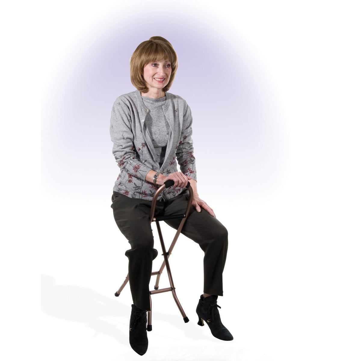 Folding cane with sling seat in bronze finish, shown with woman seated on the built-in seat, smiling