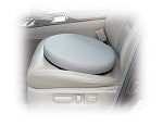 Padded swivel seat cushion placed on a car seat, shown in gray fabric with a round shape